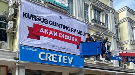 Hillmen Academy hairdressing course banner at Ayer Keroh, Melaka, MY displayed outside a building.