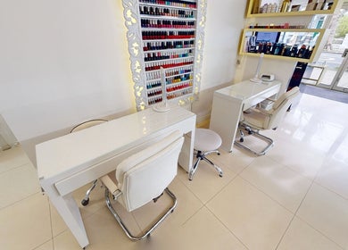 Chic nail station at Da Silva Hair & Beauty, London, England, GB, featuring sleek decor and vibrant polish options.