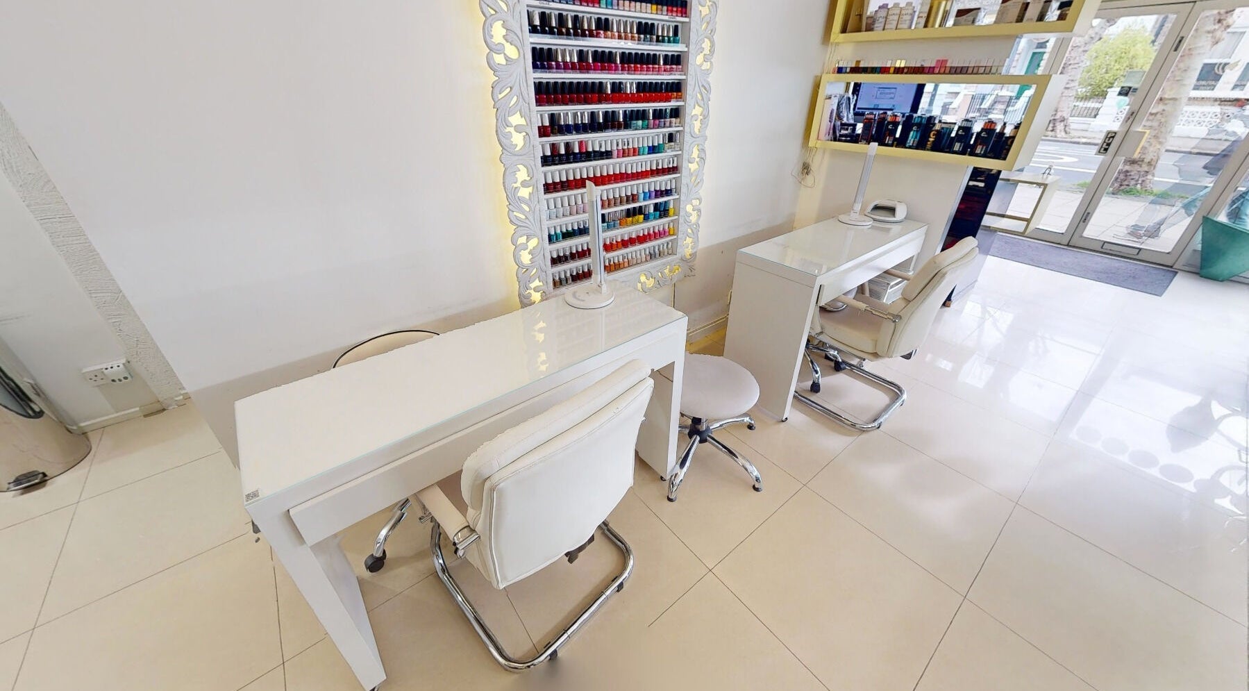 Chic nail station at Da Silva Hair & Beauty, London, England, GB, featuring sleek decor and vibrant polish options.
