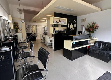 Elegant interior of Da Silva Hair & Beauty in London, England, GB, showcasing sleek styling chairs and reception area.