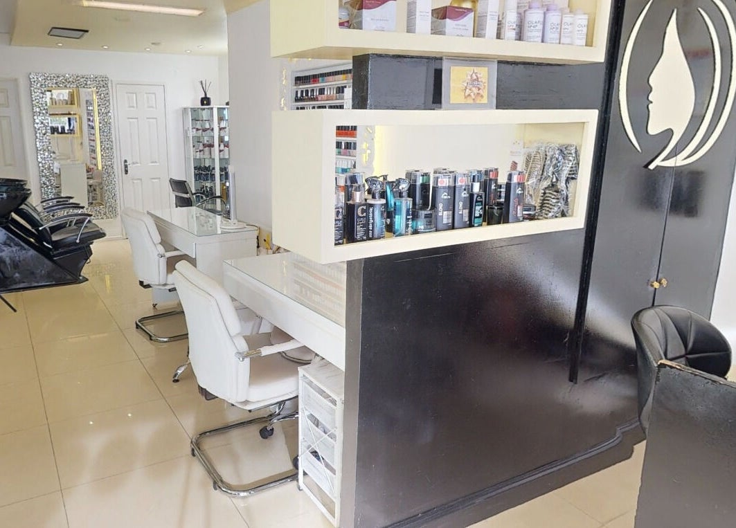 Modern salon interior at Da Silva Hair & Beauty, showcasing stylish chairs and product displays in London, England, GB.