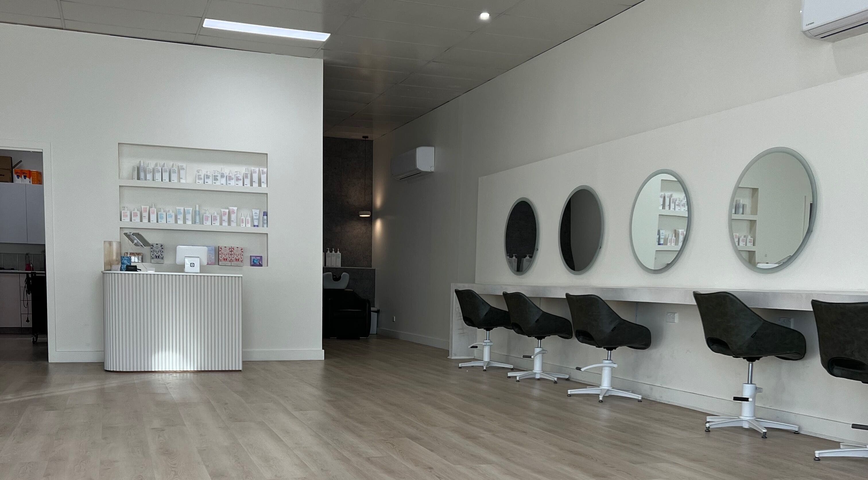 Modern salon at Brow HQ, Golden Point, Victoria, AU featuring stylish chairs and mirrored stations.
