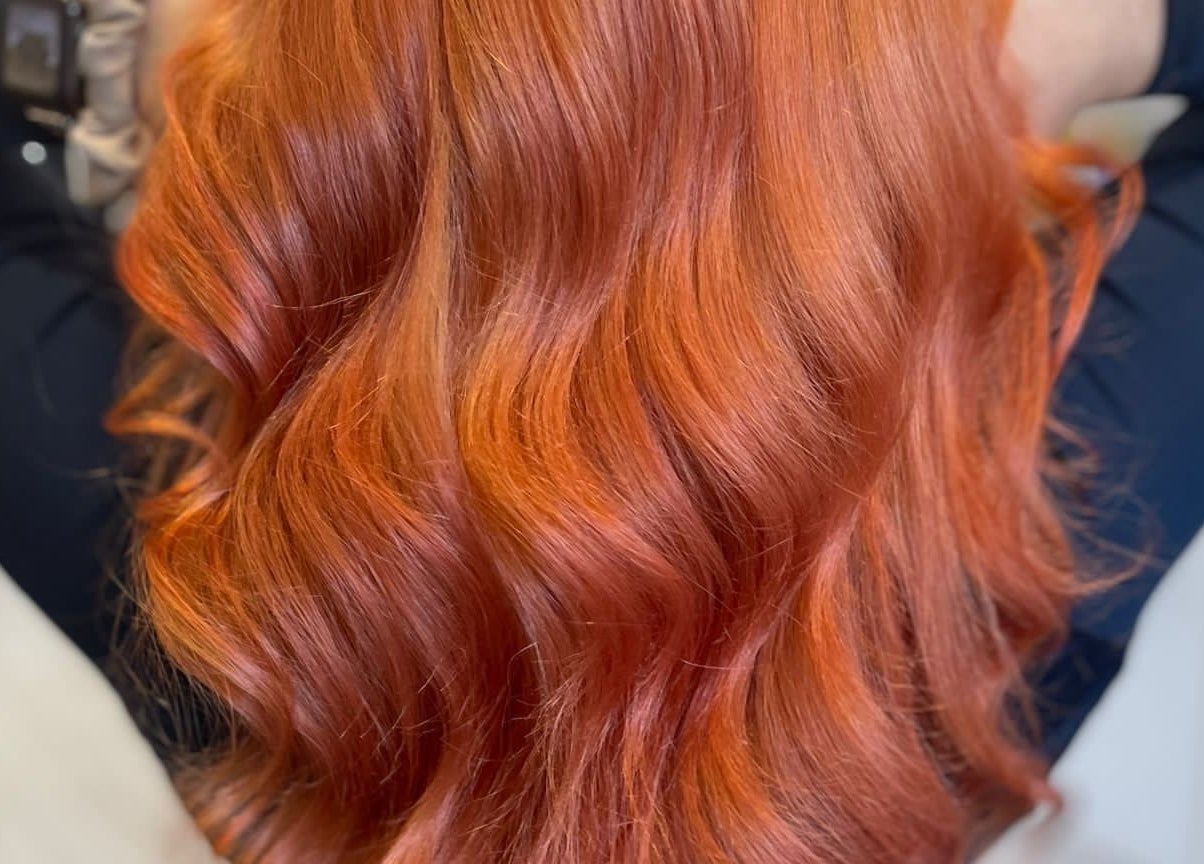 Vibrant red hair styled by Hair by Lyds in Pontypridd, Wales, GB. Perfect wavy finish adding elegant volume.