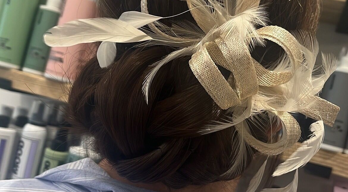 Elegant updo with feathers at Hair by Lyds in Pontypridd, Wales, GB. Perfect for special occasions.