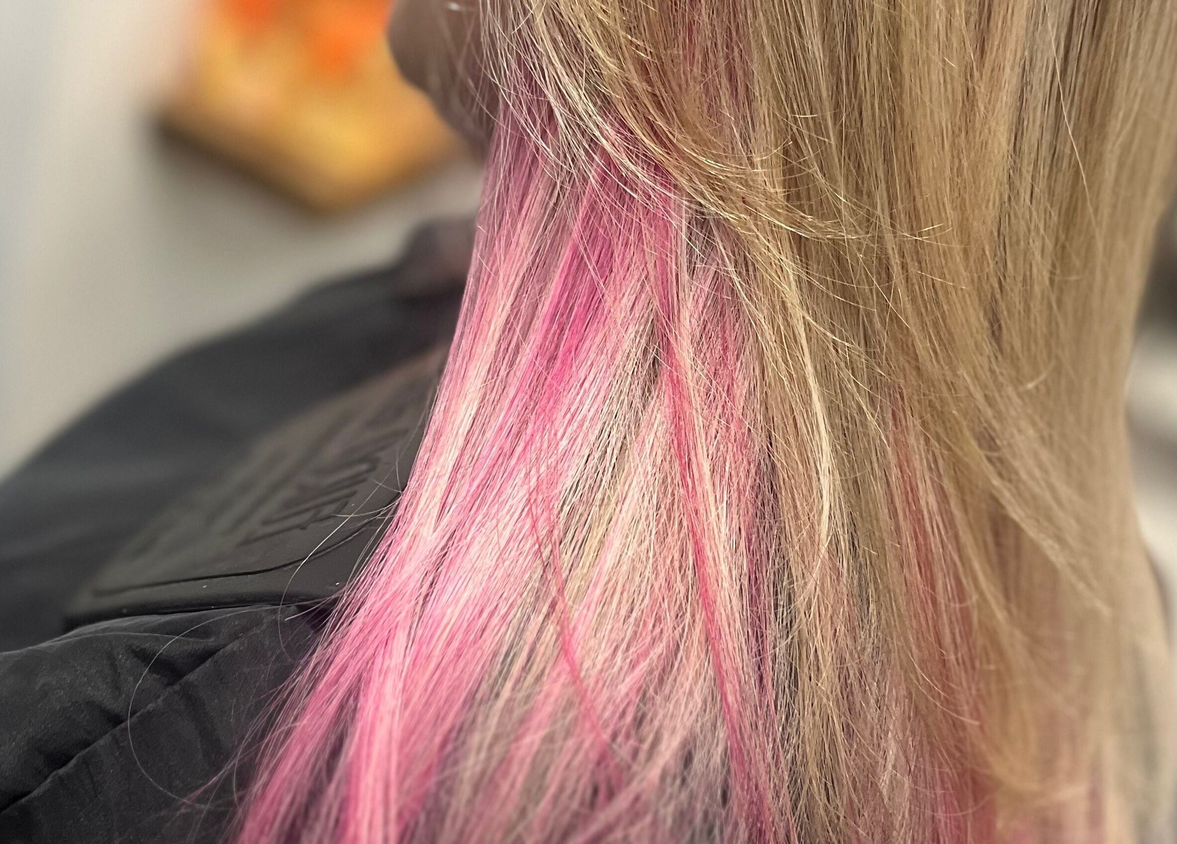 Blonde hair with vibrant pink streaks at Hair by Lyds, Pontypridd, Wales, GB.
