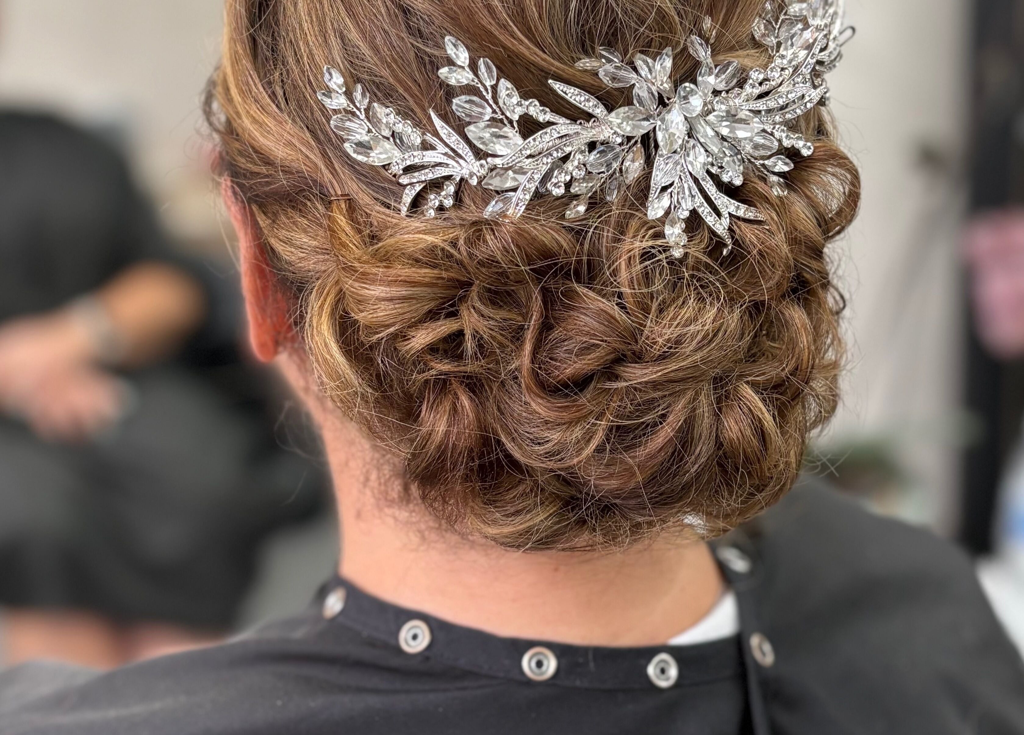 Elegant bridal updo with crystal hairpiece at Hair by Lyds in Pontypridd, Wales, GB.