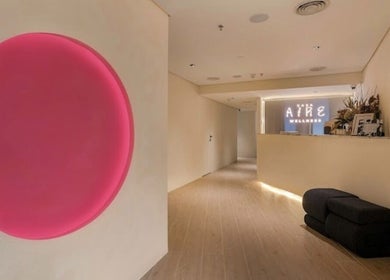 Entrance hall of Casa Aire Wellness, Dubai, Dubai, AE with a glowing pink circle art piece.