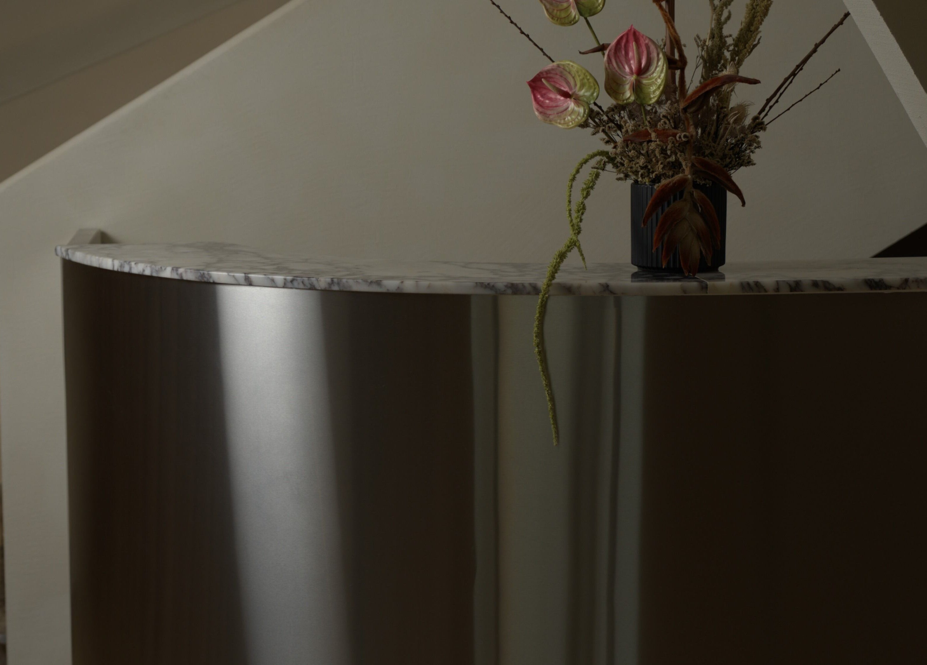 Elegant reception desk with floral arrangement at Aire MD by Casa Aire Wellness, Dubai, Dubai, AE.