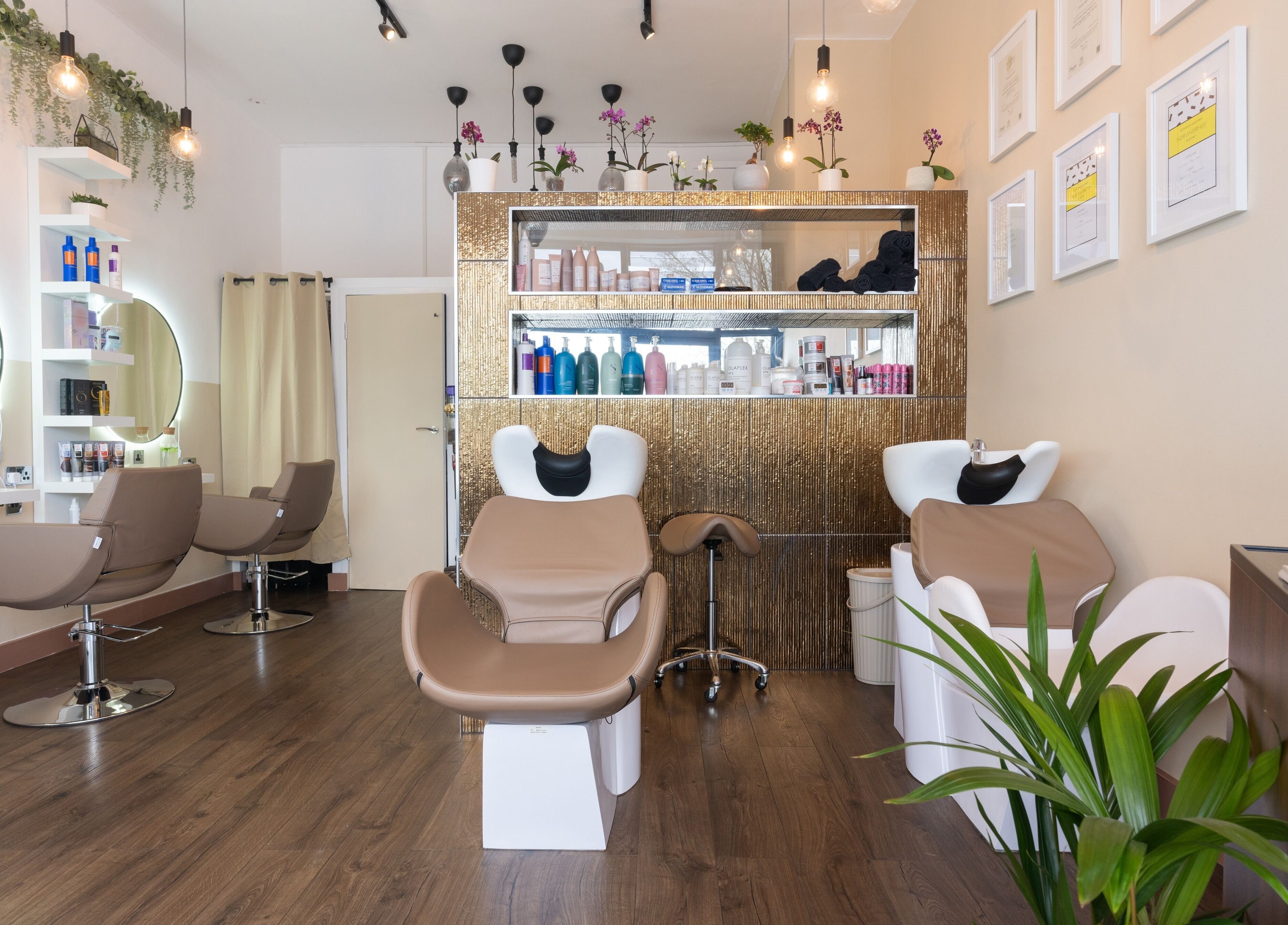 Interior of Claudia Hairstylist in London, England, GB, showcasing modern salon chairs and stylish decor.