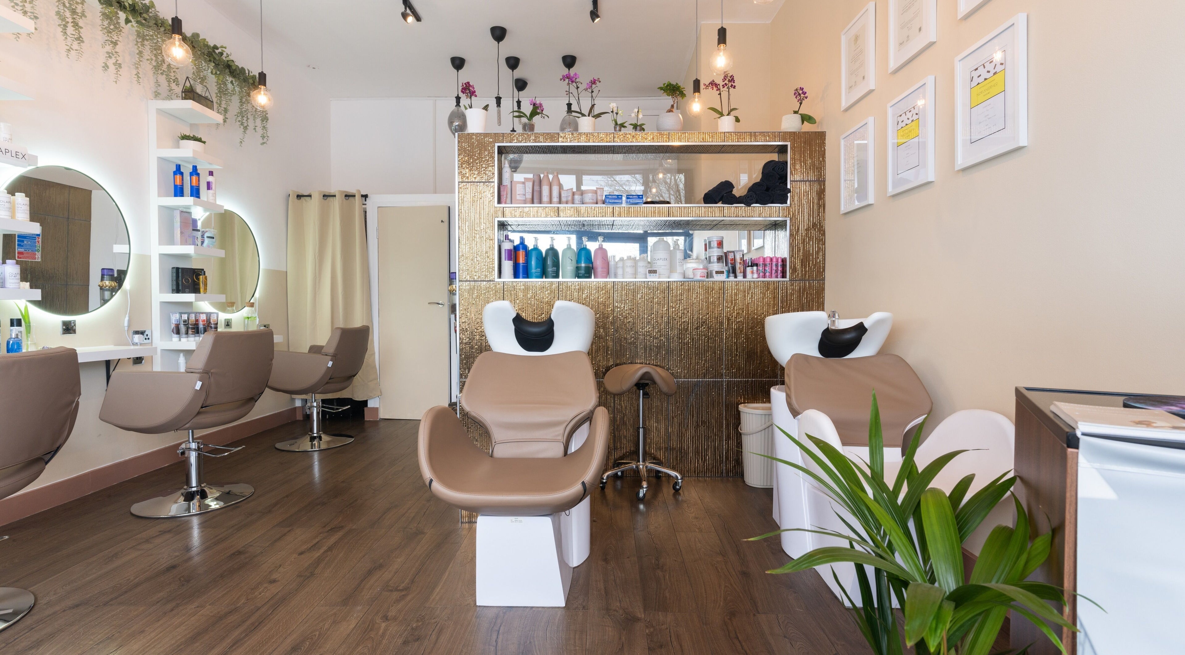 Interior of Claudia Hairstylist in London, England, GB, showcasing modern salon chairs and stylish decor.