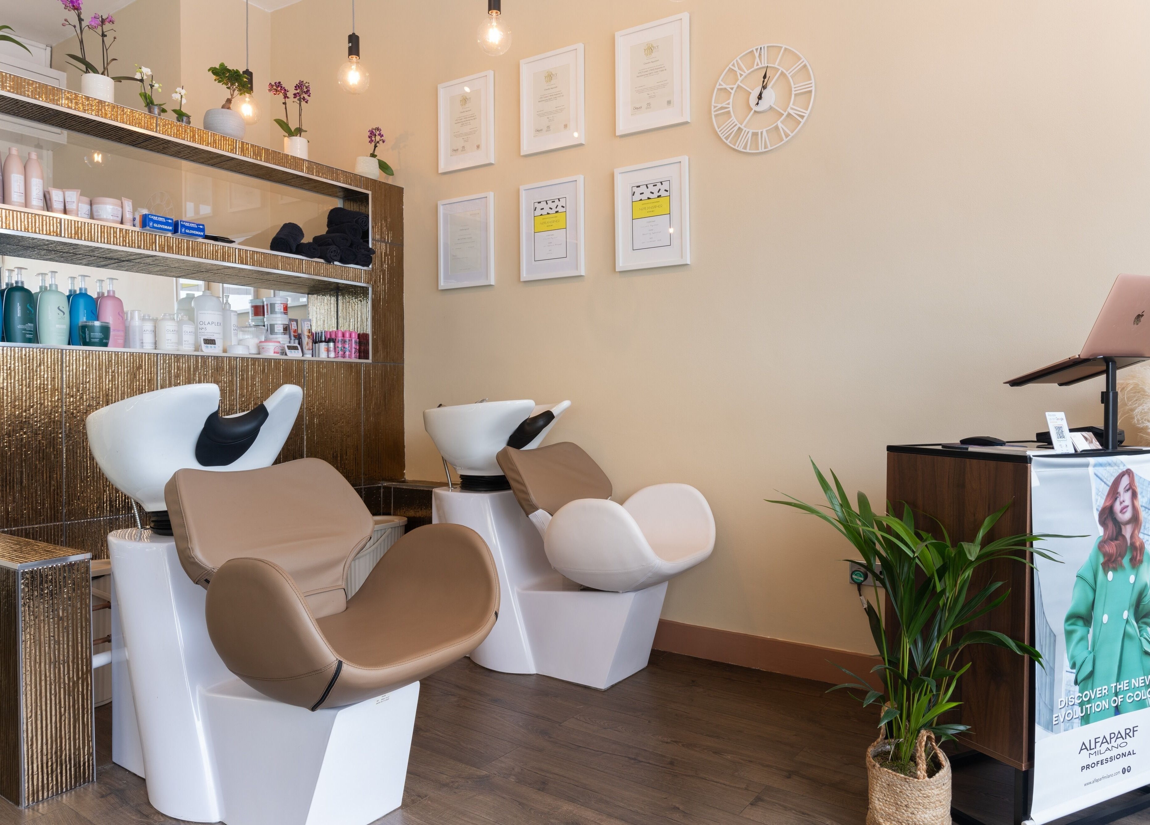 Modern hair-washing station at Claudia Hairstylist, London, England, GB, featuring elegant decor and products.