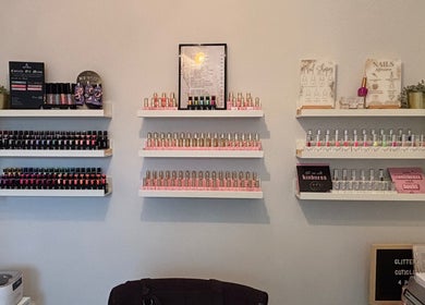 Nail polish display at The Nail Nook, Horley, England, GB featuring colorful bottles and decor.