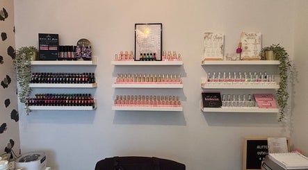 Nail polish display at The Nail Nook, Horley, England, GB featuring colorful bottles and decor.
