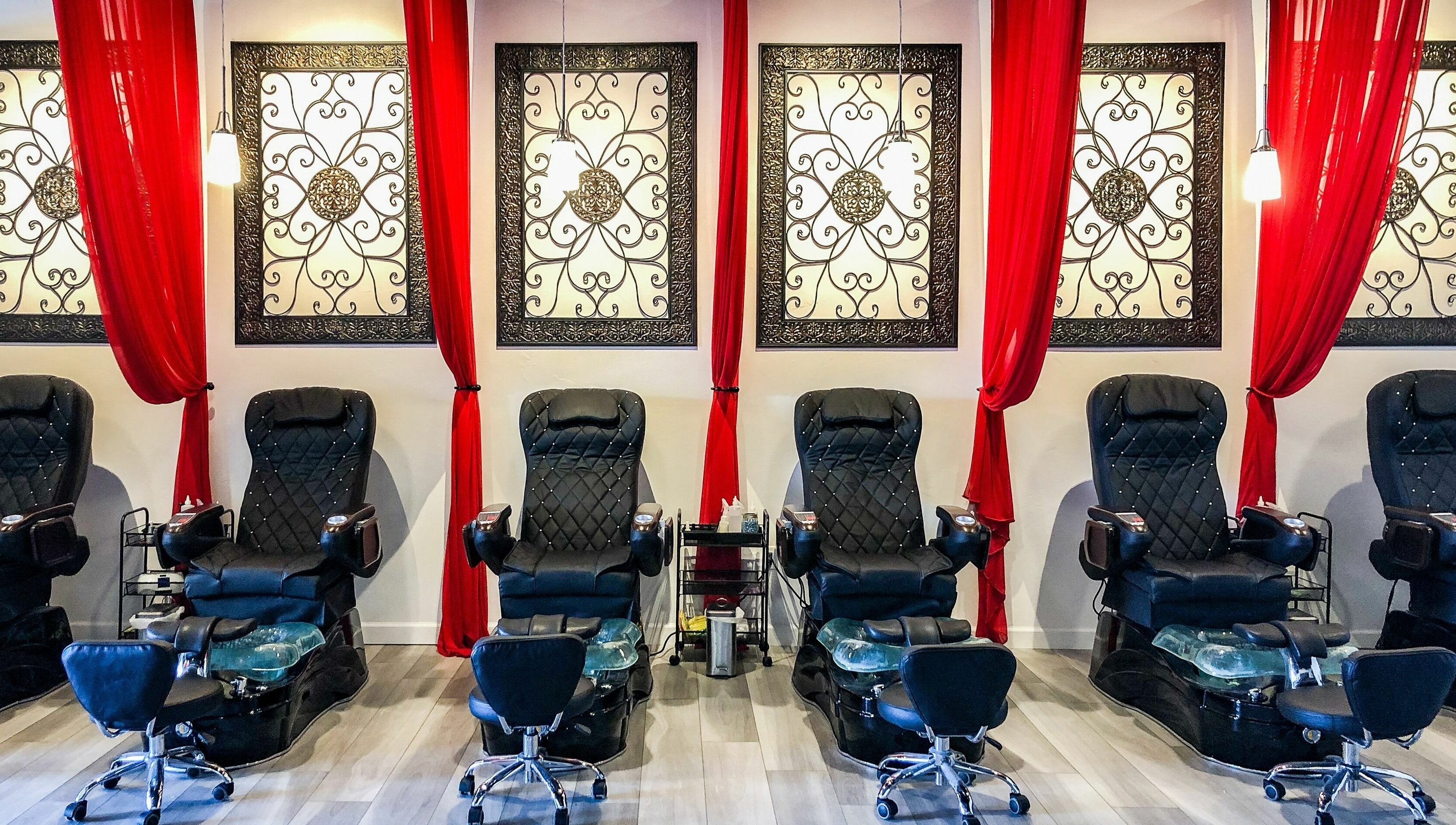 Elegant pedicure chairs at Kimberly Nail Salon, Kimberly, Wisconsin, US, with stylish decor and red curtains.