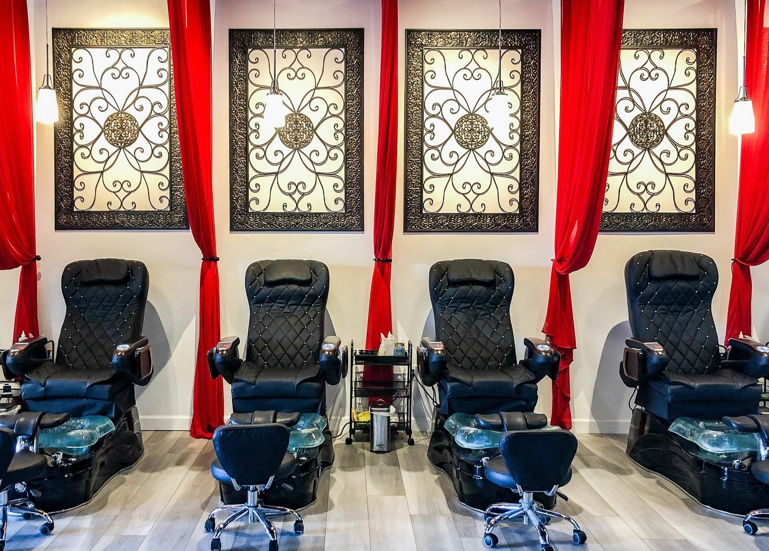 Elegant pedicure chairs at Kimberly Nail Salon, Kimberly, Wisconsin, US, with stylish decor and red curtains.