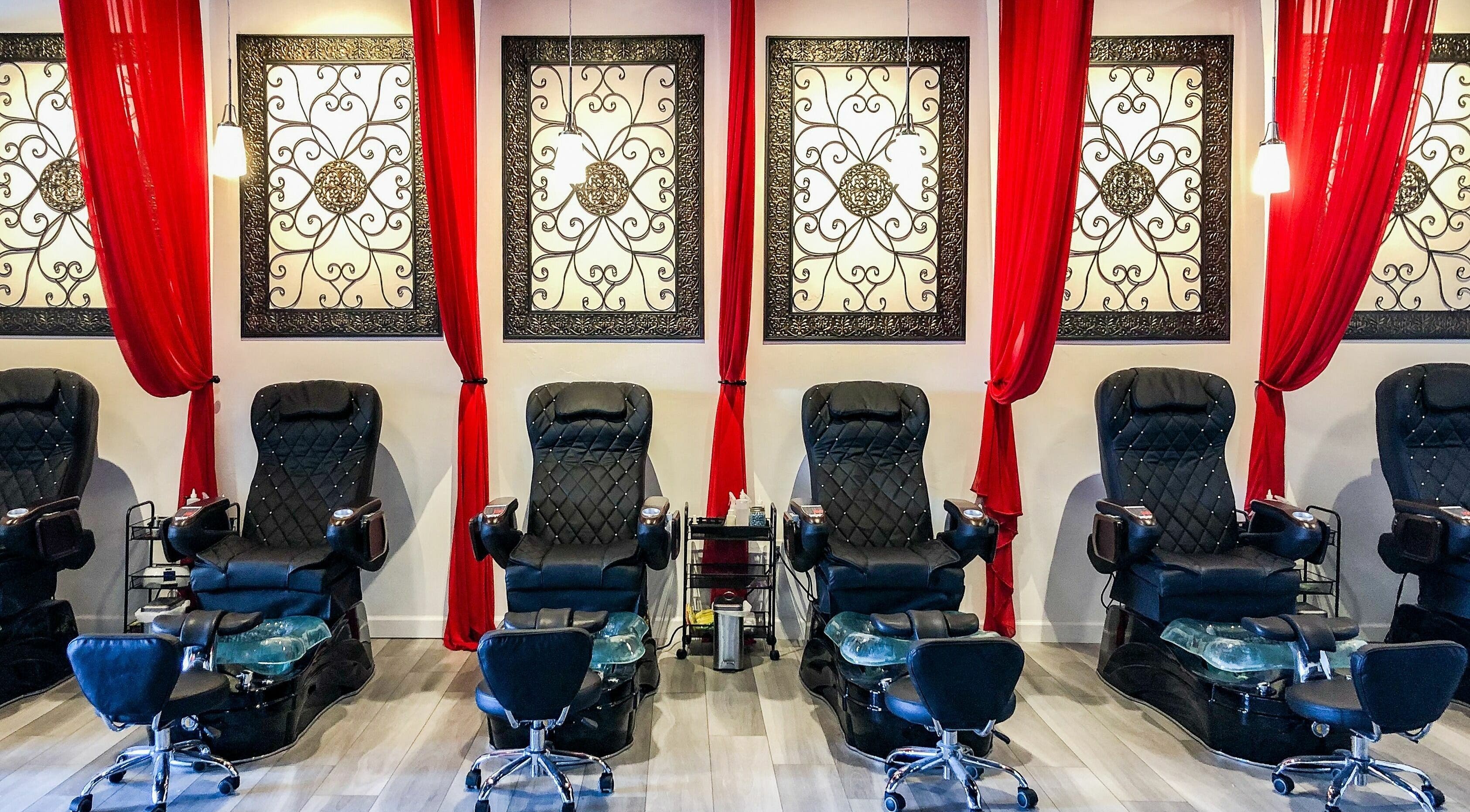 Elegant pedicure chairs at Kimberly Nail Salon, Kimberly, Wisconsin, US, with stylish decor and red curtains.
