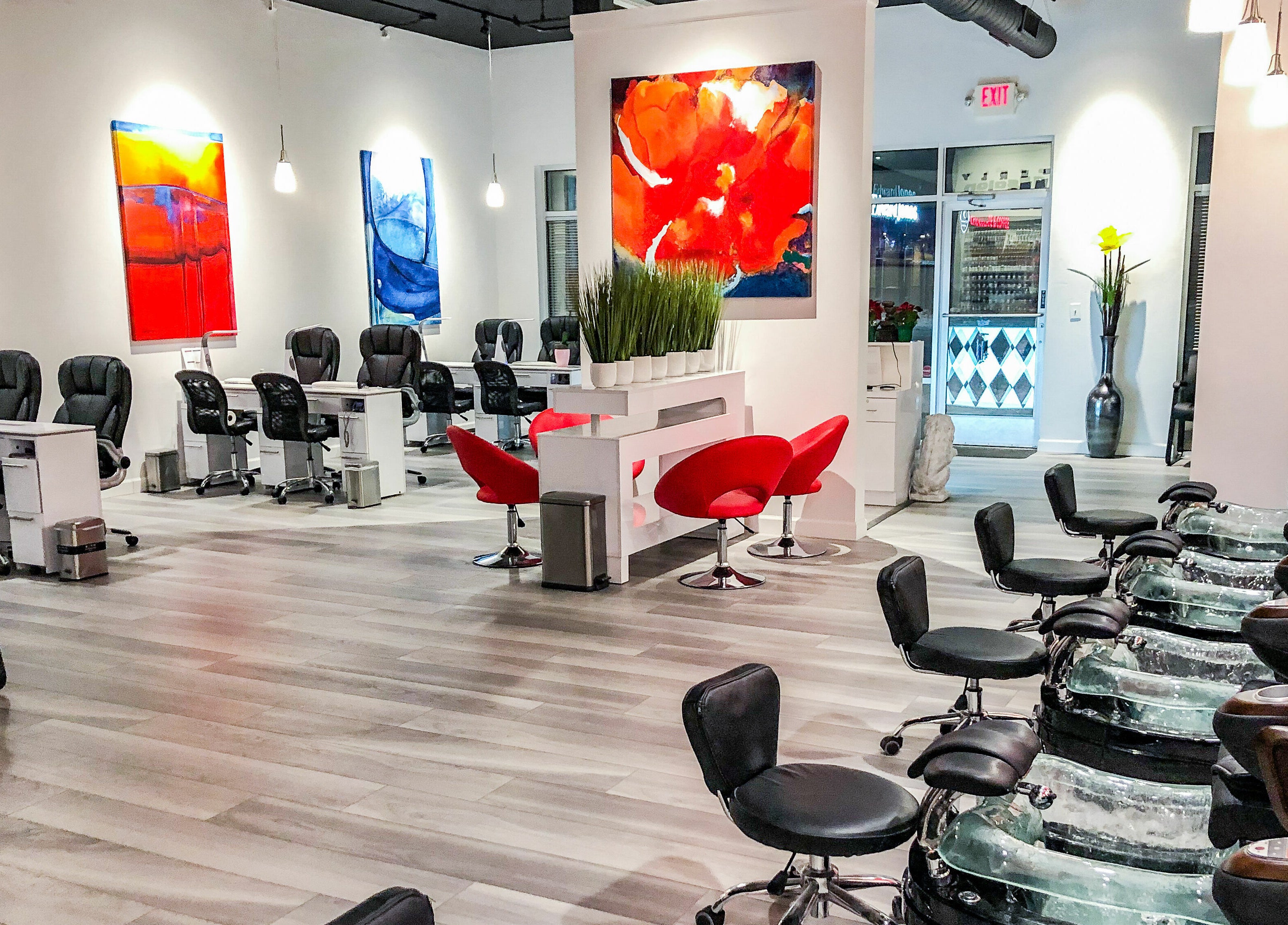 Modern interior of Kimberly Nail Salon in Kimberly, Wisconsin, US with sleek chairs and vibrant artwork.