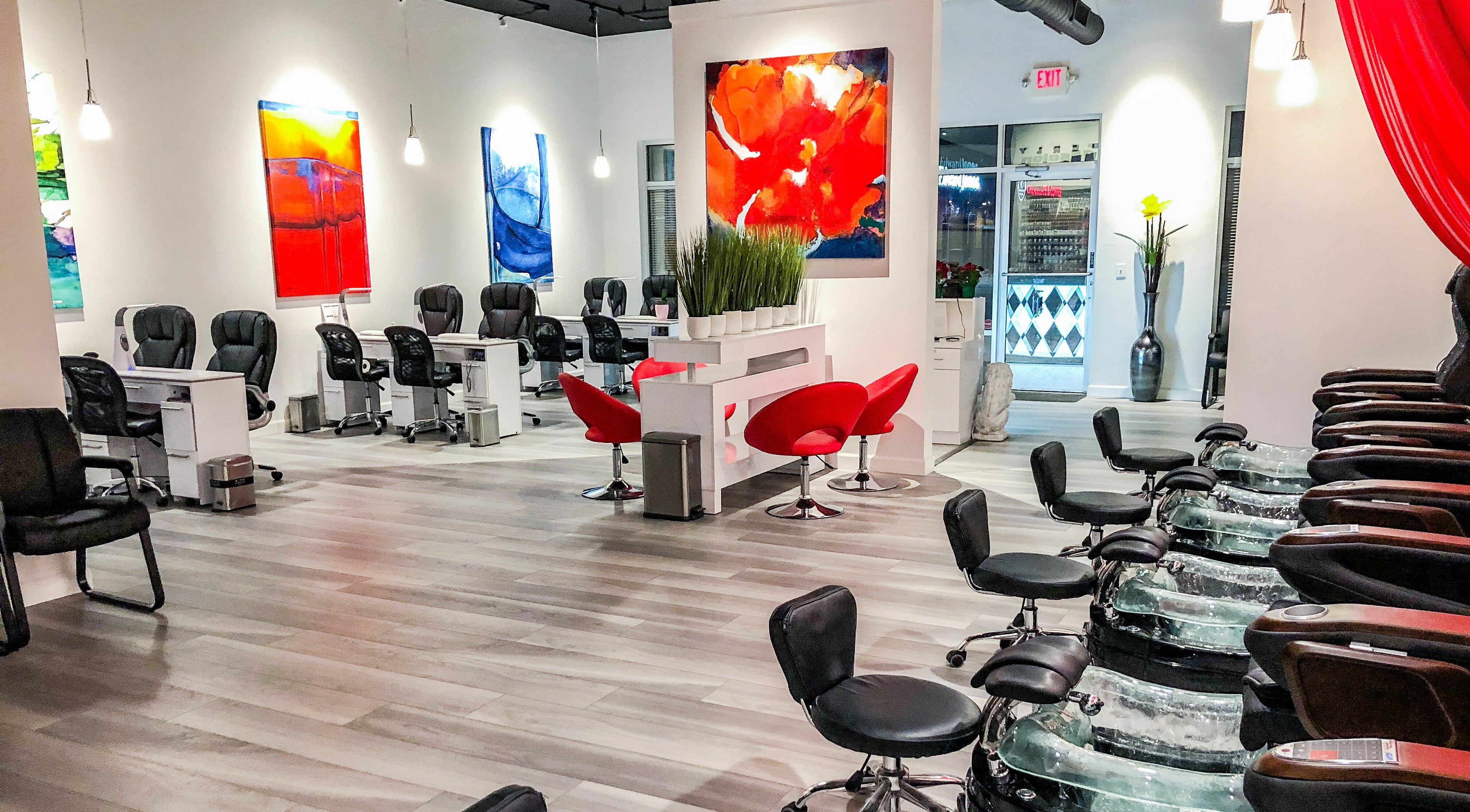 Modern interior of Kimberly Nail Salon in Kimberly, Wisconsin, US with sleek chairs and vibrant artwork.