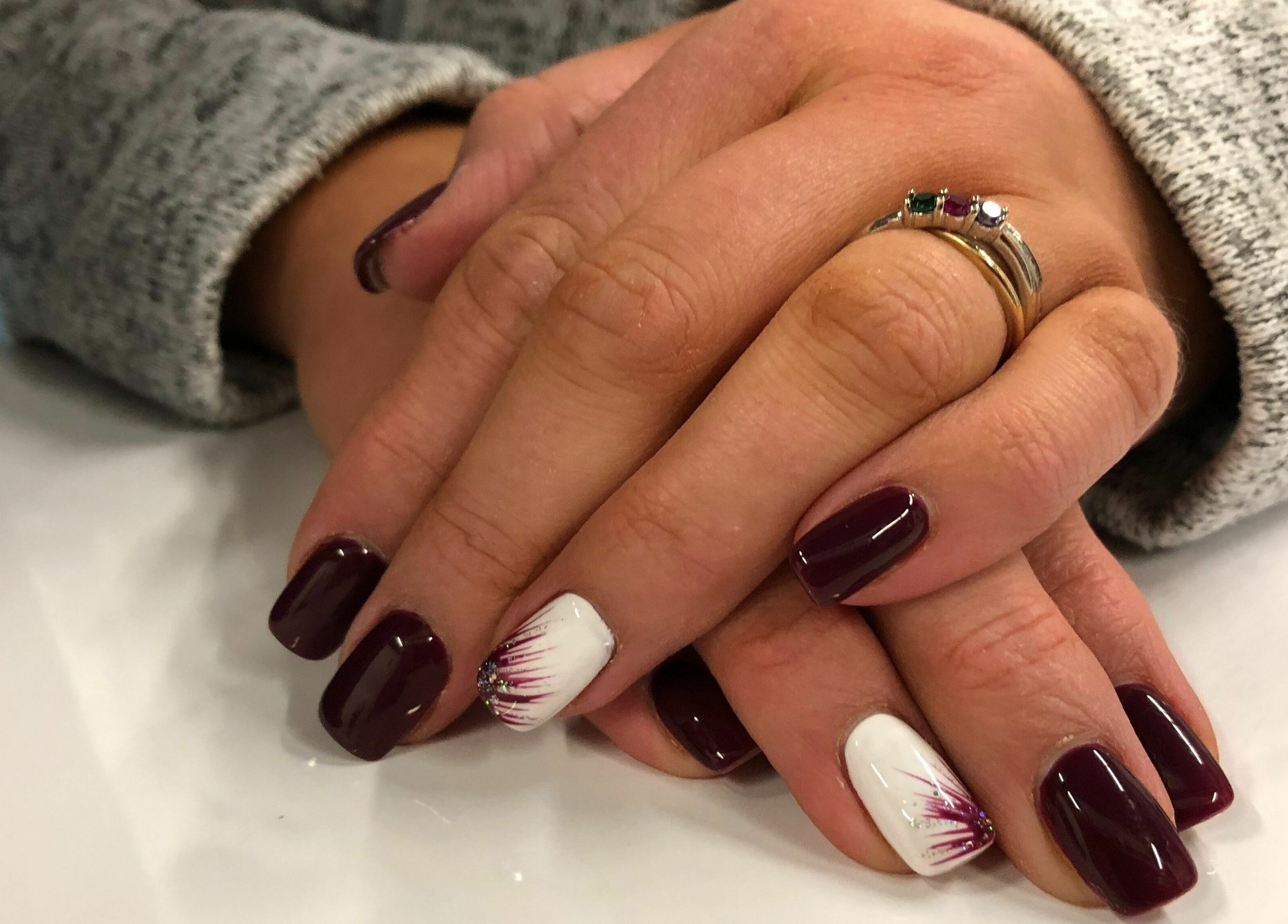 Manicure with dark and white nail art at Kimberly Nail Salon in Kimberly, Wisconsin, US.