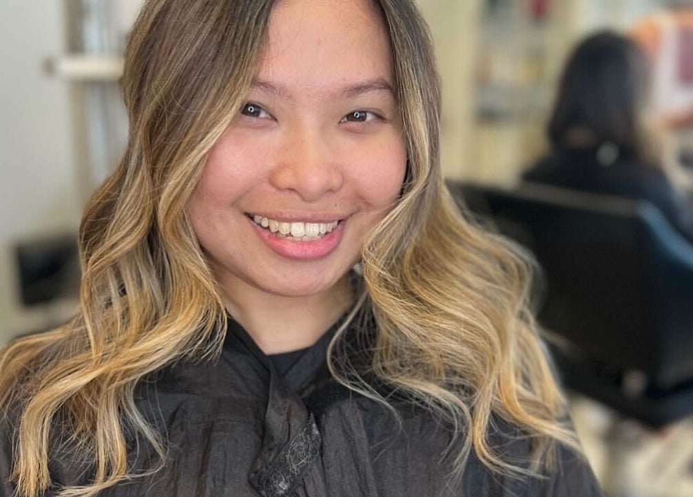 Woman with styled blonde waves at Styled by Court, Sutton, England, GB. Hair salon ambiance enhances her look.