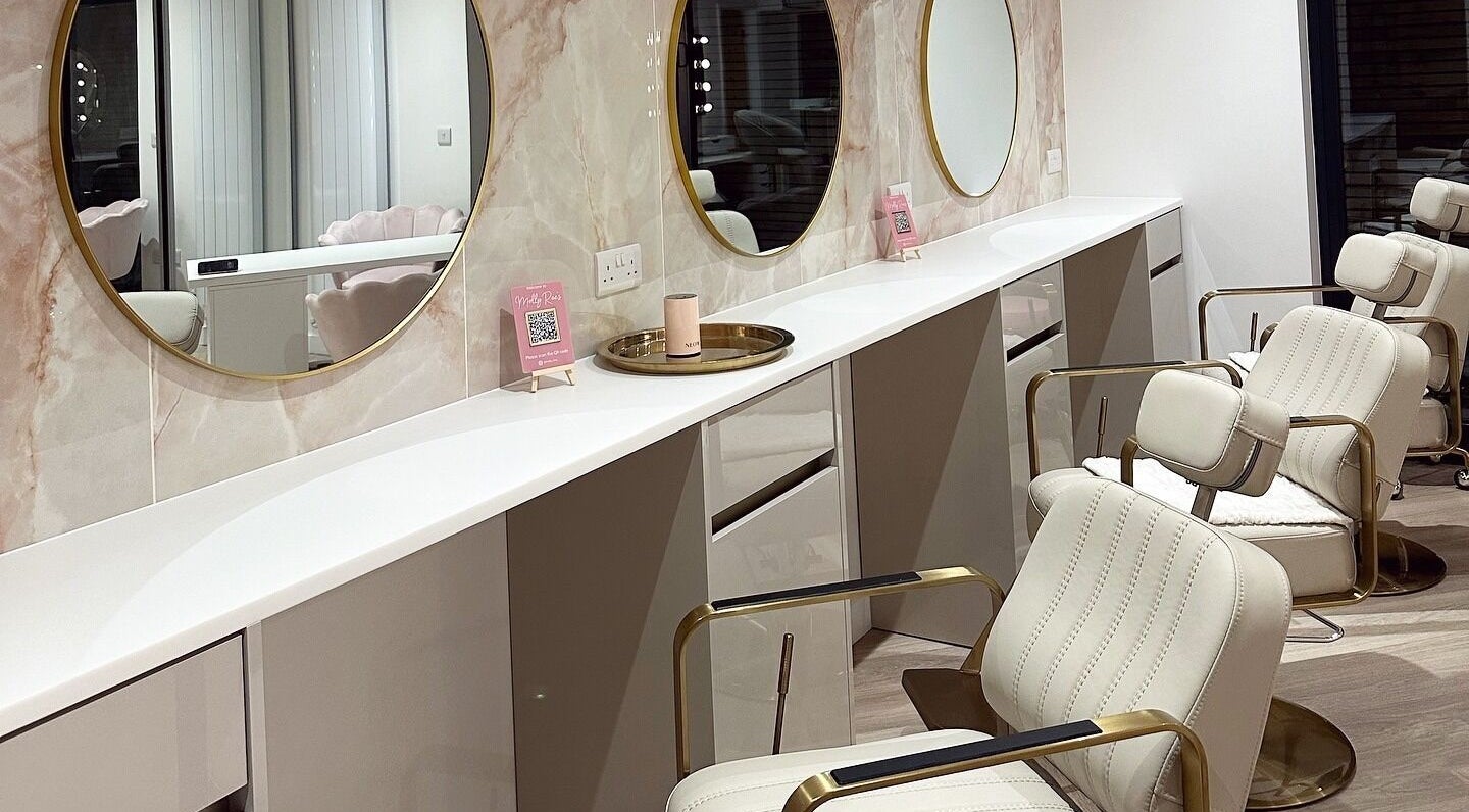 Chic beauty salon interior at Molly Rae's in York, England, GB with stylish mirrors and plush seating.