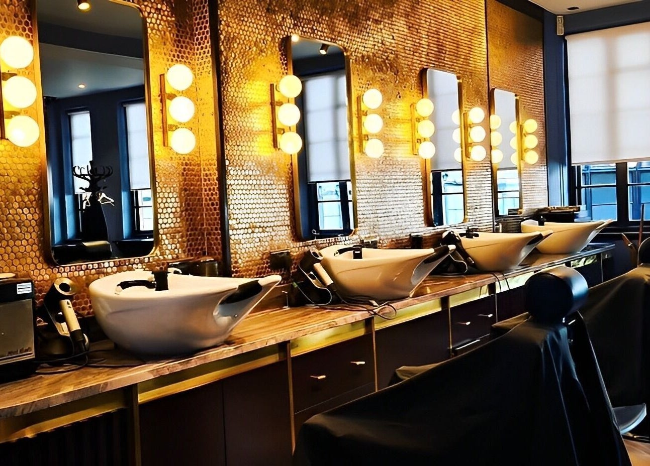 Sophisticated interior of Avanzato Grooming Lounge in London, England, GB with stylish salon stations.