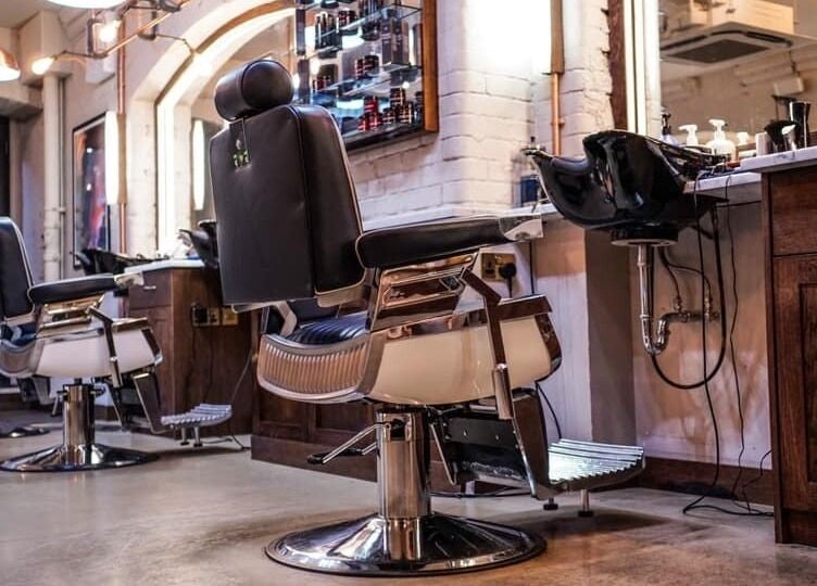 Sleek barber chairs at Avanzato Grooming Lounge in London, England, GB showcasing modern luxury.