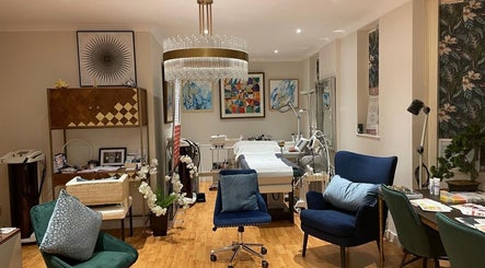 Elegant treatment room at Sabrina Aesthetic, London, England, GB with modern decor and cozy seating.