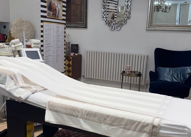 Elegant treatment room at Sabrina Aesthetic, London, England, GB, featuring a stylish chair and modern equipment.