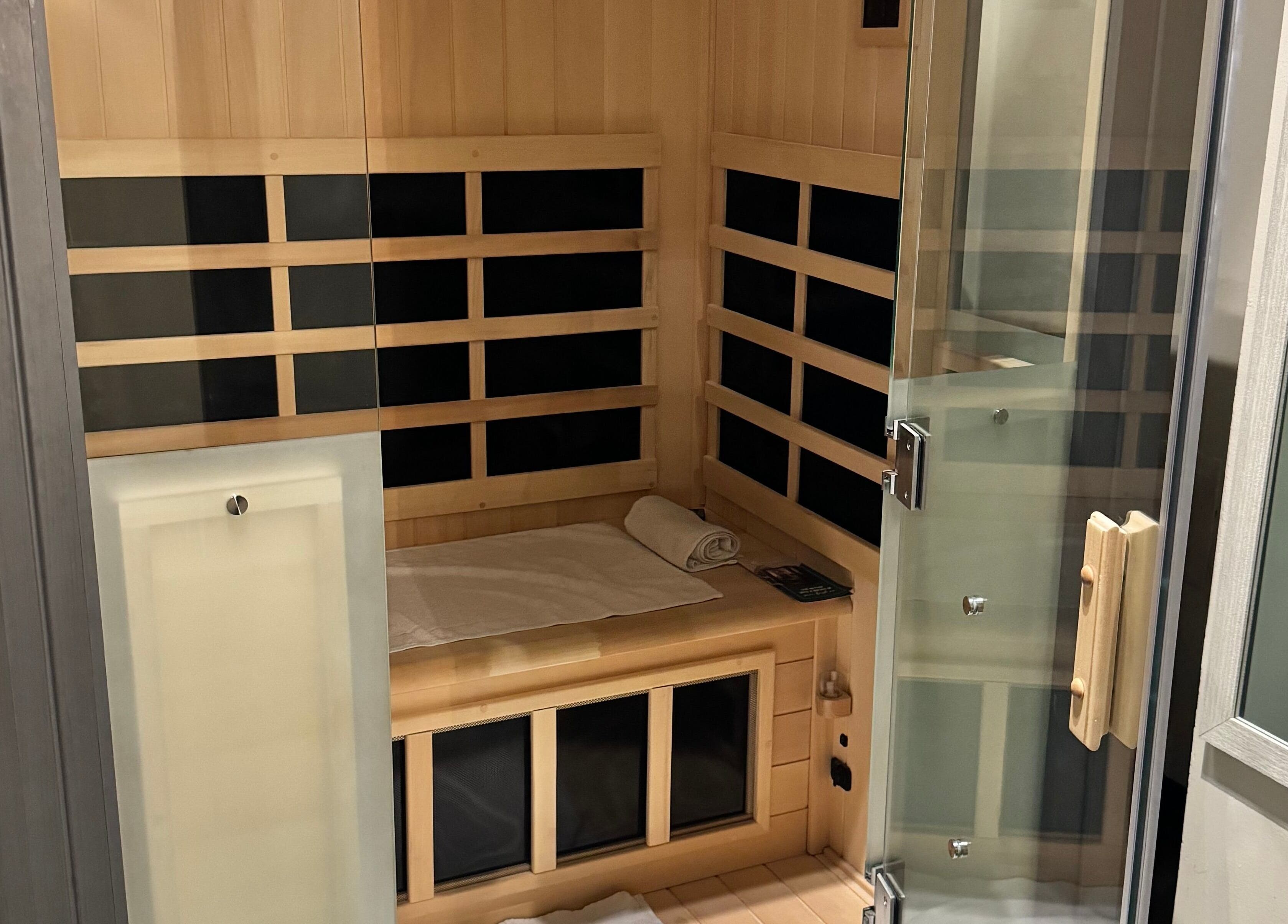 Luxurious sauna at Tuscany Studio, Hamilton, Ontario, CA, offering relaxation in a serene wood-lined space.