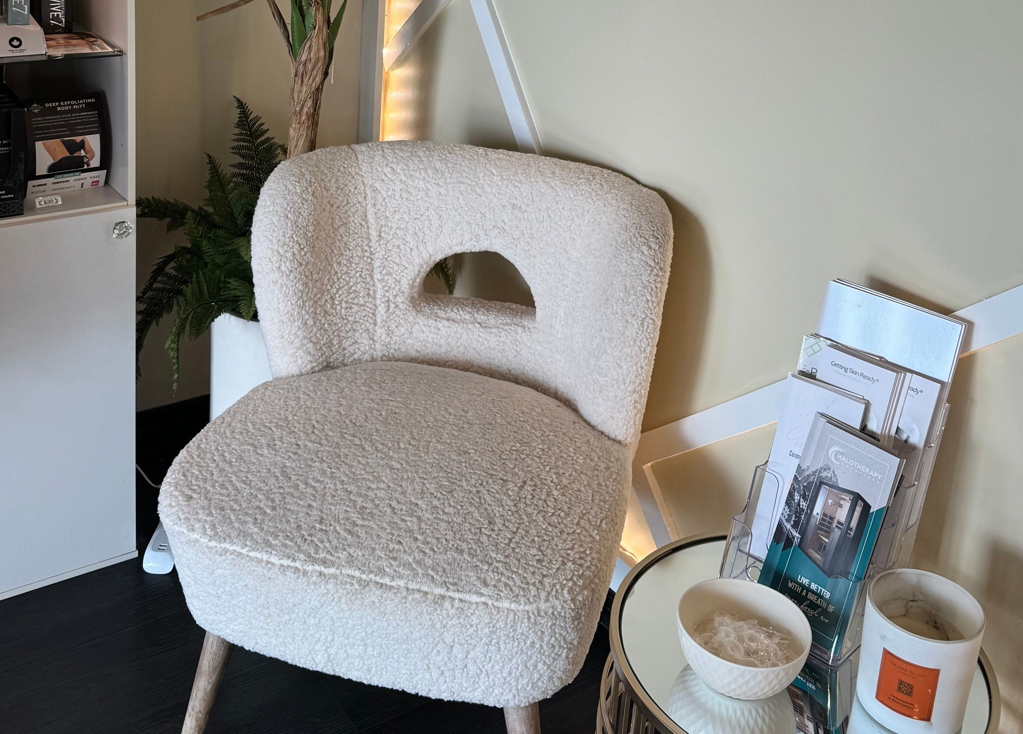 A plush chair and brochures in Tuscany Studio's tranquil corner, Hamilton, Ontario, CA.