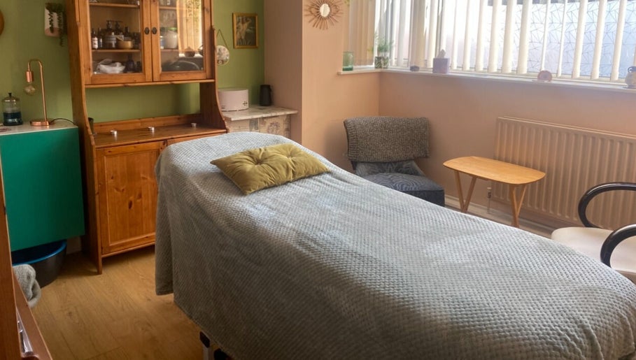 Calm therapy room at Ethical Beauty, Bristol, England, GB with cozy decor and massage table.