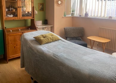 Calm therapy room at Ethical Beauty, Bristol, England, GB with cozy decor and massage table.