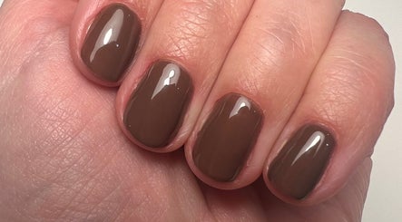 Close-up of polished brown nails at Lucy Watson Beauty, Horsham, England, GB.