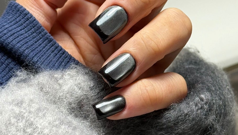 Elegant black Russian manicure at Legend nails, New York, New York, US showcases glossy nail art.