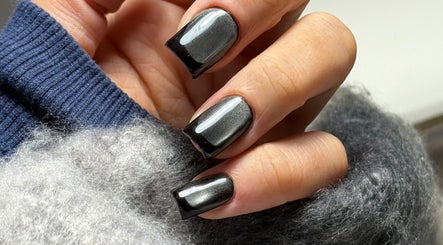 Elegant black Russian manicure at Legend nails, New York, New York, US showcases glossy nail art.