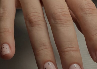 Elegant Russian manicure with dotted design at Legend Nails in New York, New York, US.