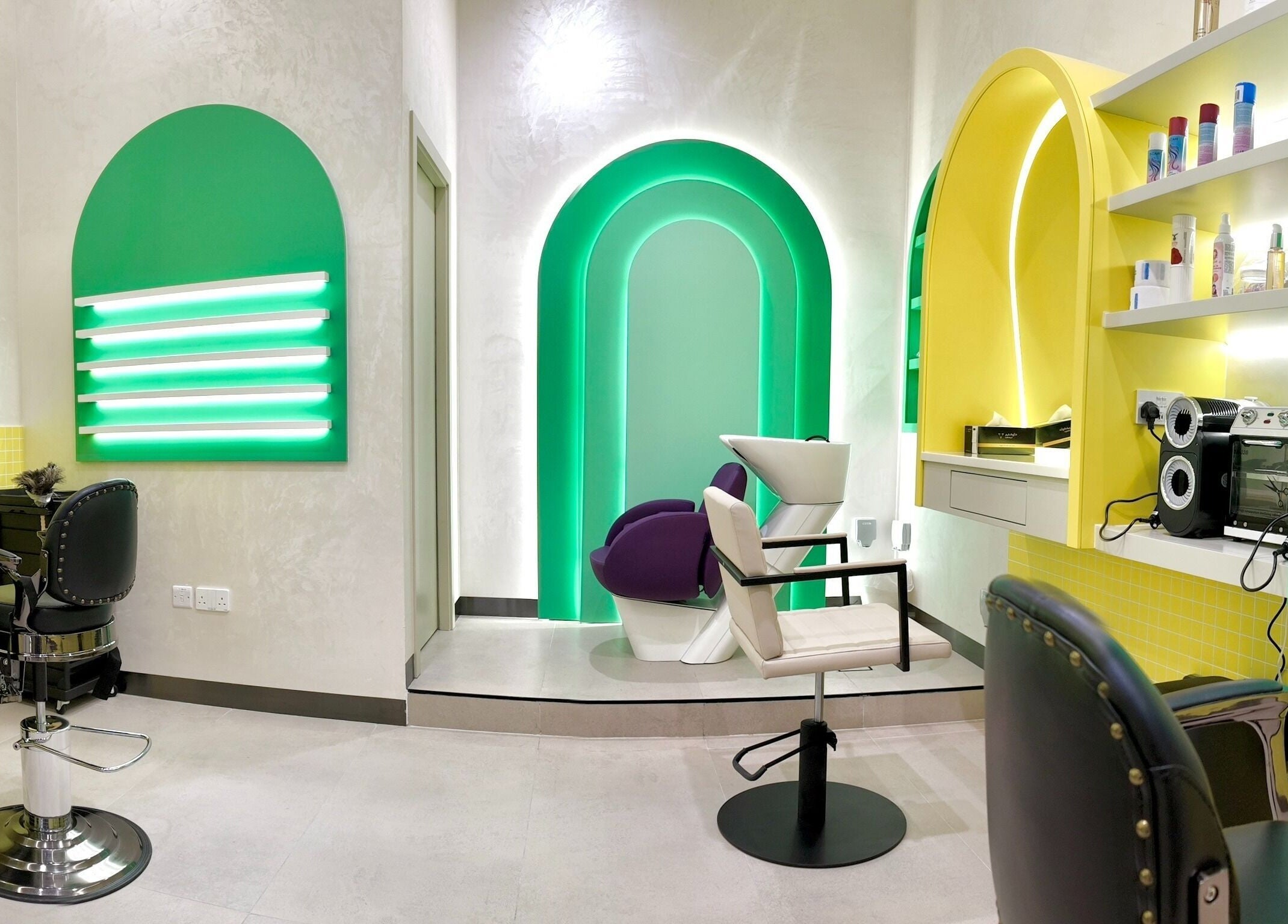 Bright salon at Stories Kids - Mohamed Bin Zayed, Abu Dhabi. Cheerful decor and modern styling stations.