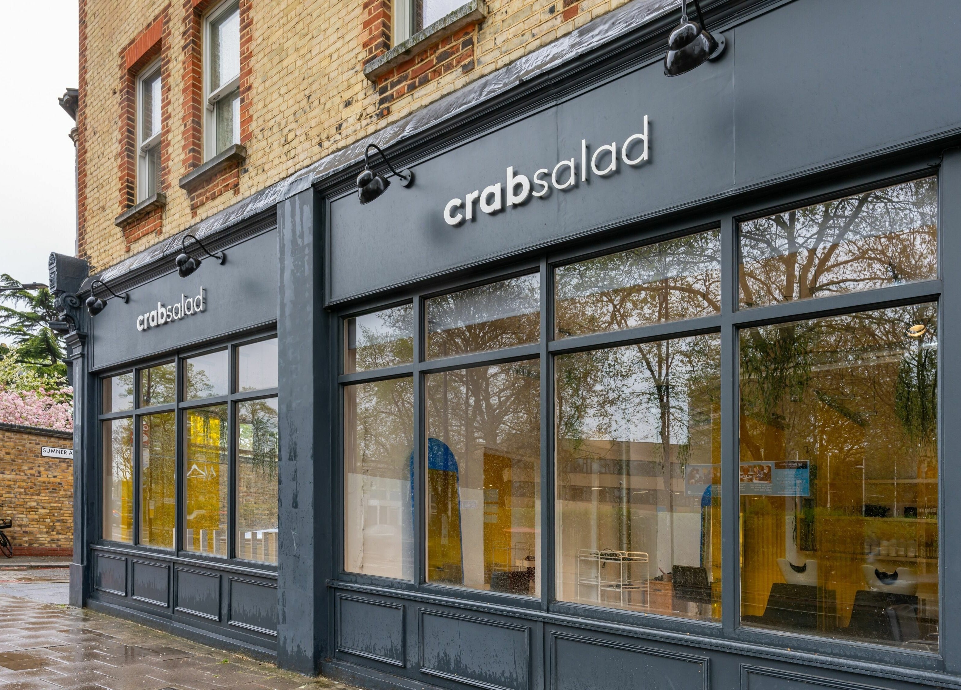 Front exterior of Crab Salad Peckham, London, GB showcasing large windows and modern signage.