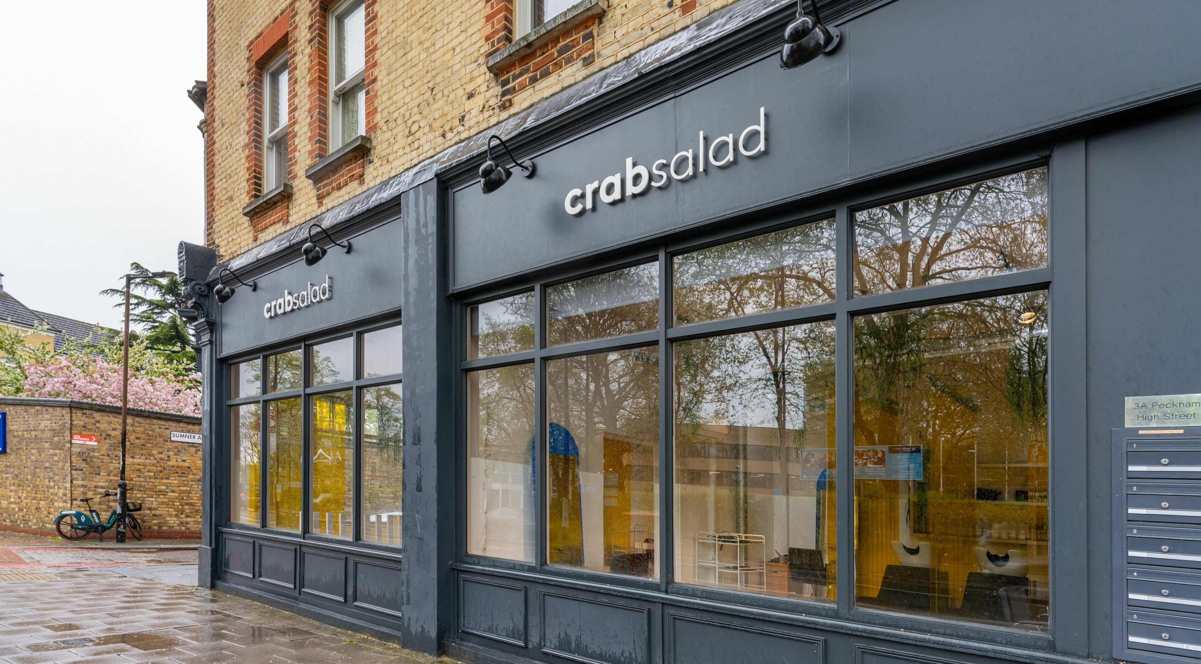 Front exterior of Crab Salad Peckham, London, GB showcasing large windows and modern signage.
