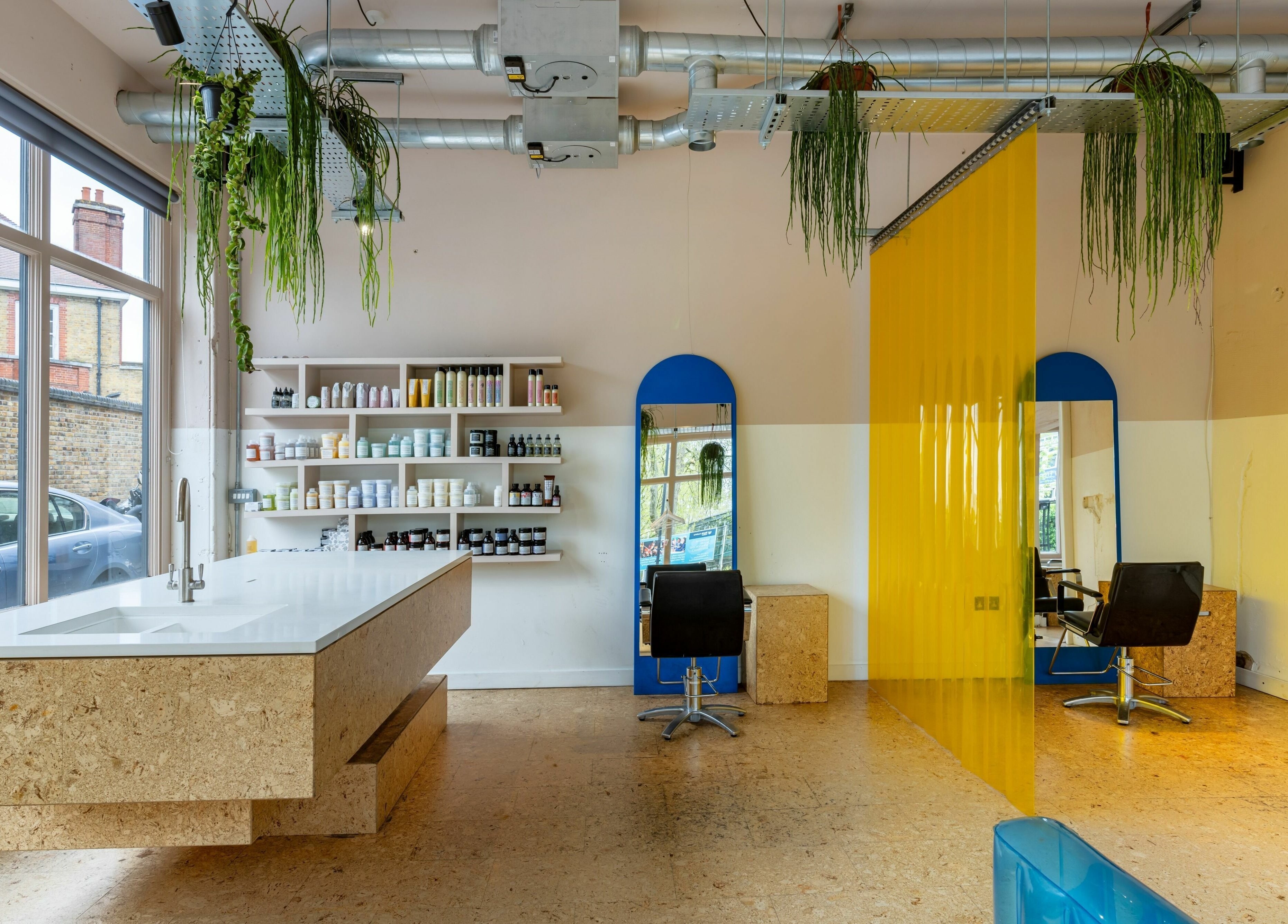 Spacious salon interior at Crab Salad Peckham, London, GB, featuring bright mirrors and modern styling chairs.
