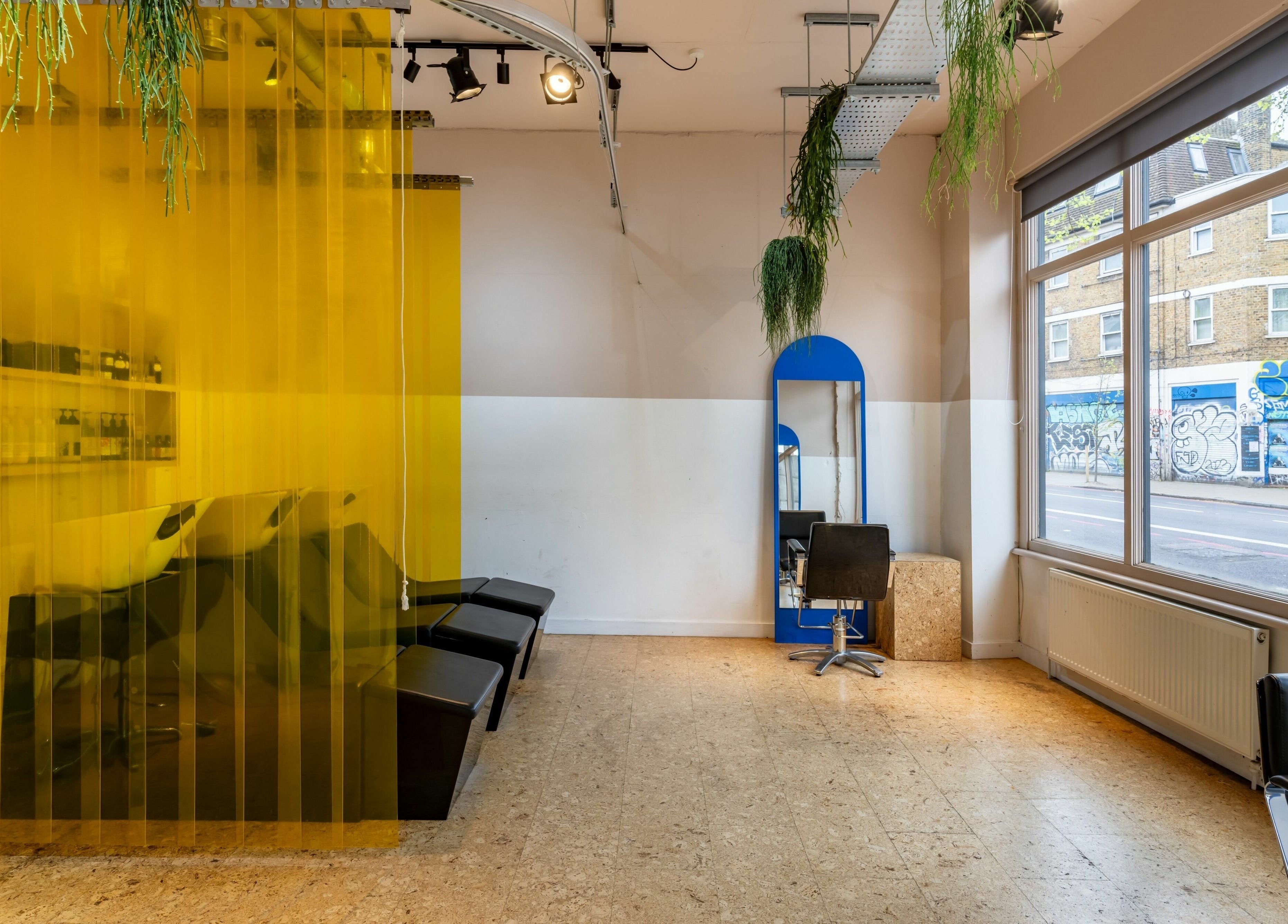 Modern salon interior at Crab Salad Peckham, London, GB, featuring large windows and stylish decor.