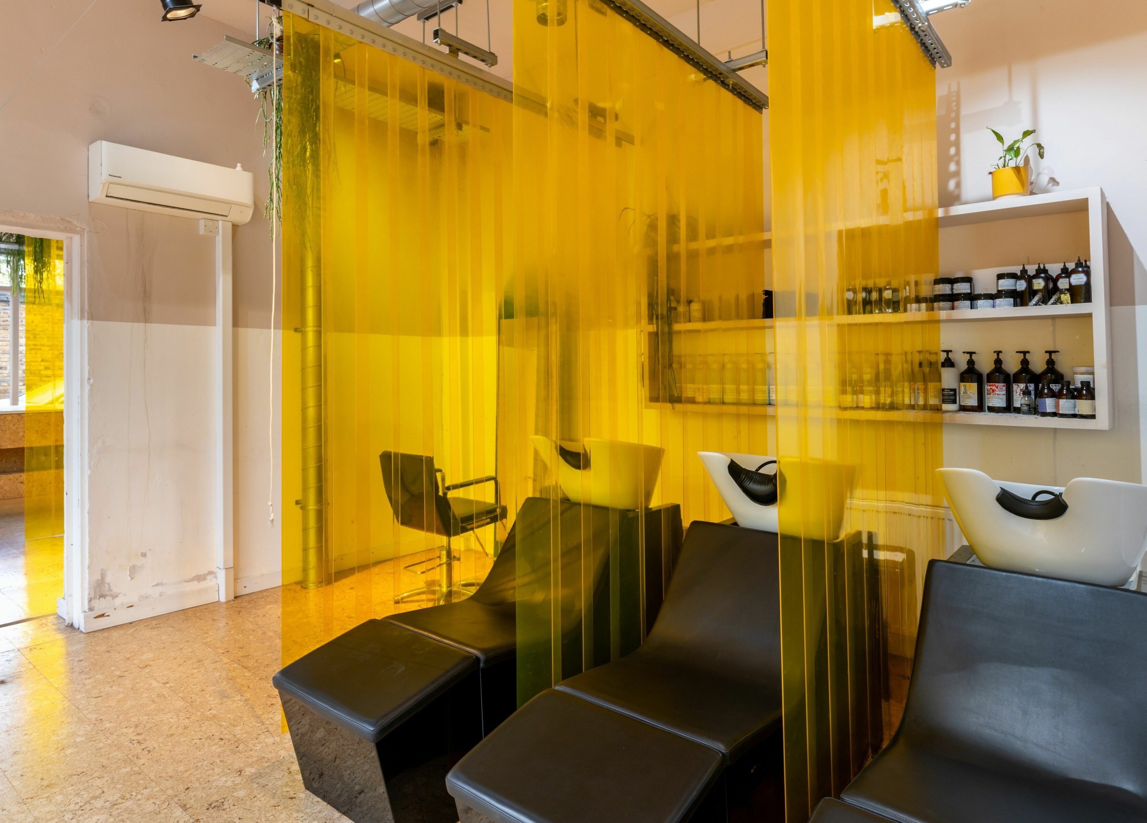 Modern hair wash station at Crab Salad Peckham, vibrant yellow decor, creating a cozy atmosphere in London, GB.