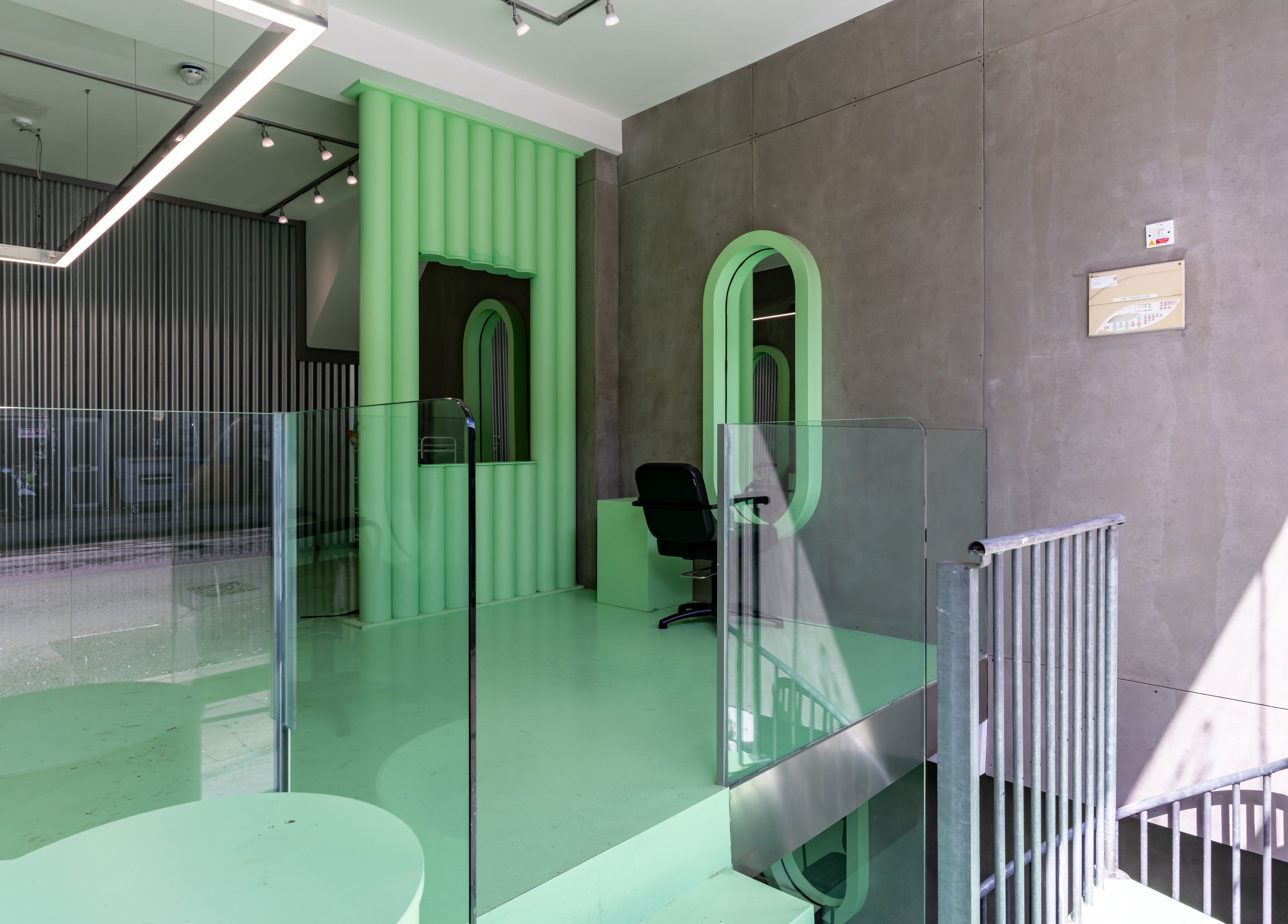 Chic interior of Crab Salad Highbury, London, GB featuring green design and sleek seating area.