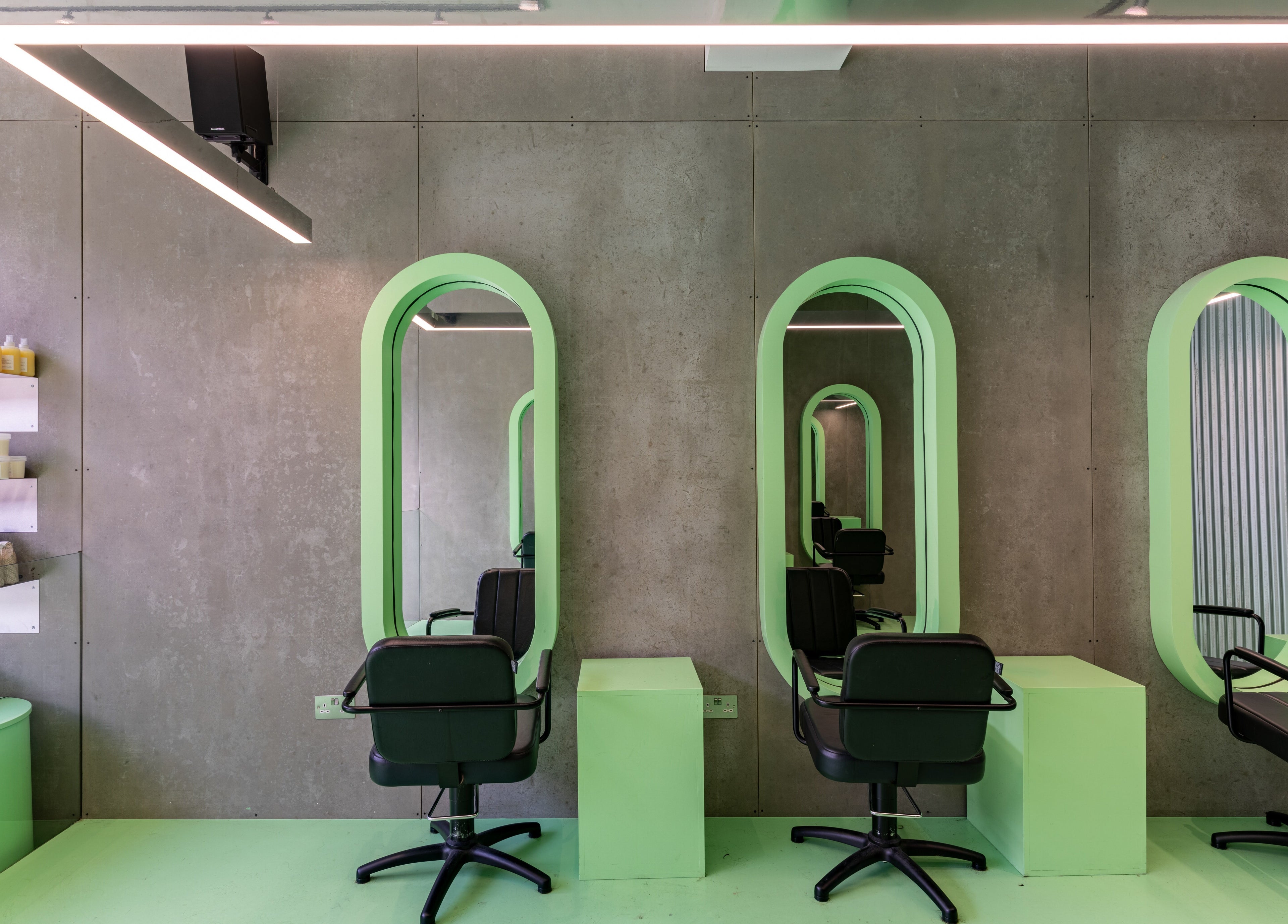 Modern salon chairs and mirrors at Crab Salad Highbury, London, GB offering stylish beauty services.