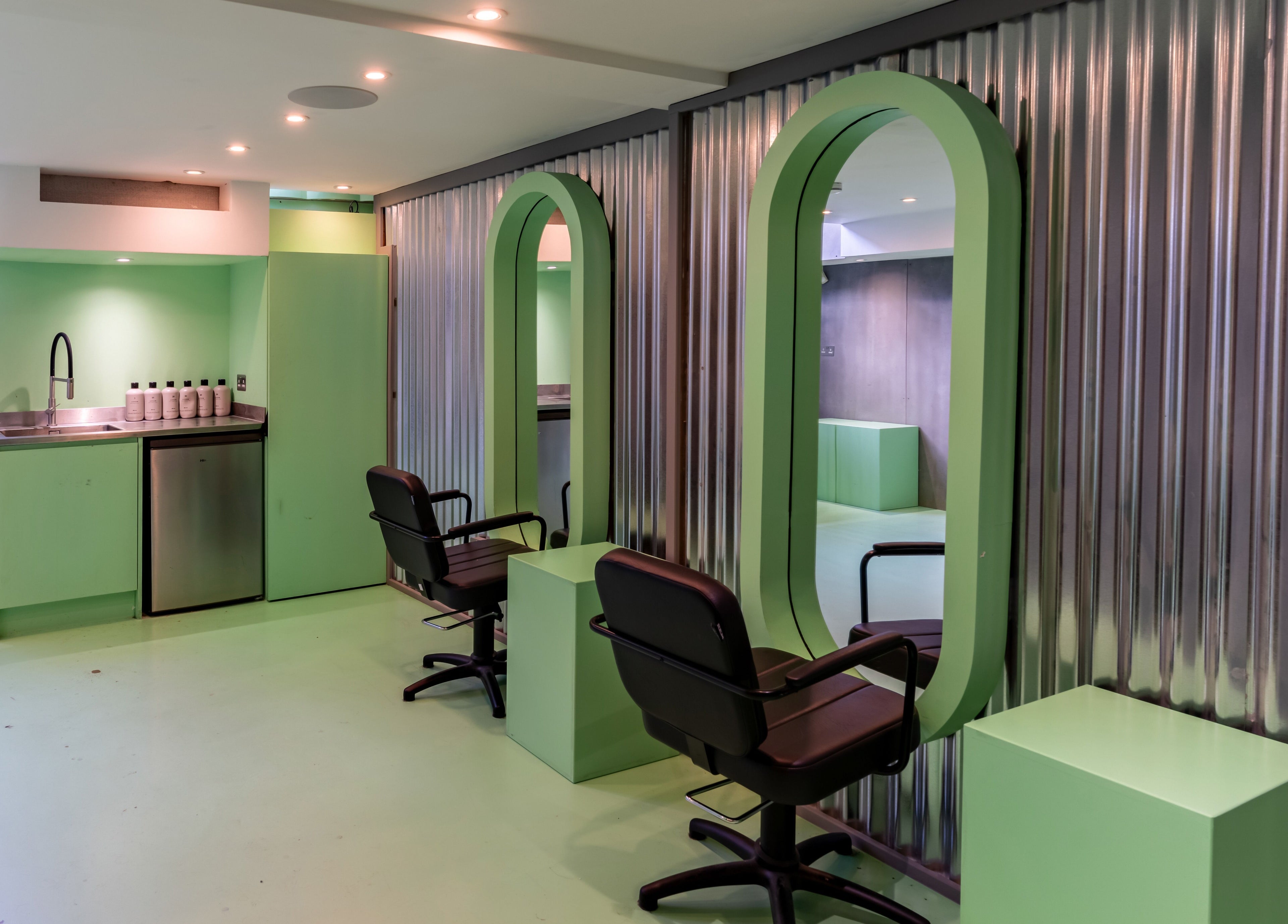 Chic beauty salon at Crab Salad Highbury, London, GB, featuring stylish green decor and elegant seating.