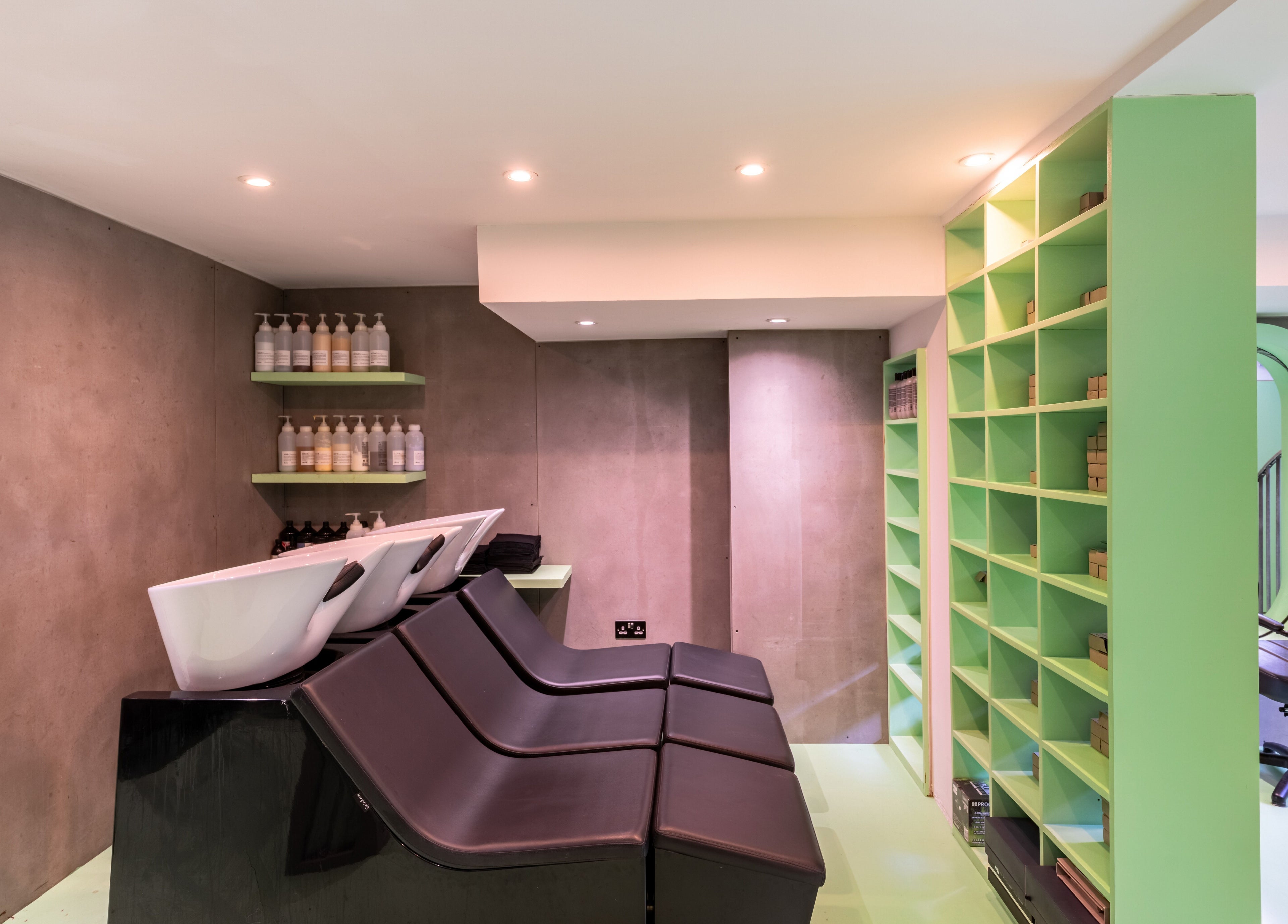 Modern salon wash stations and shelves at Crab Salad Highbury, London, GB enhancing beauty and wellness ambiance.