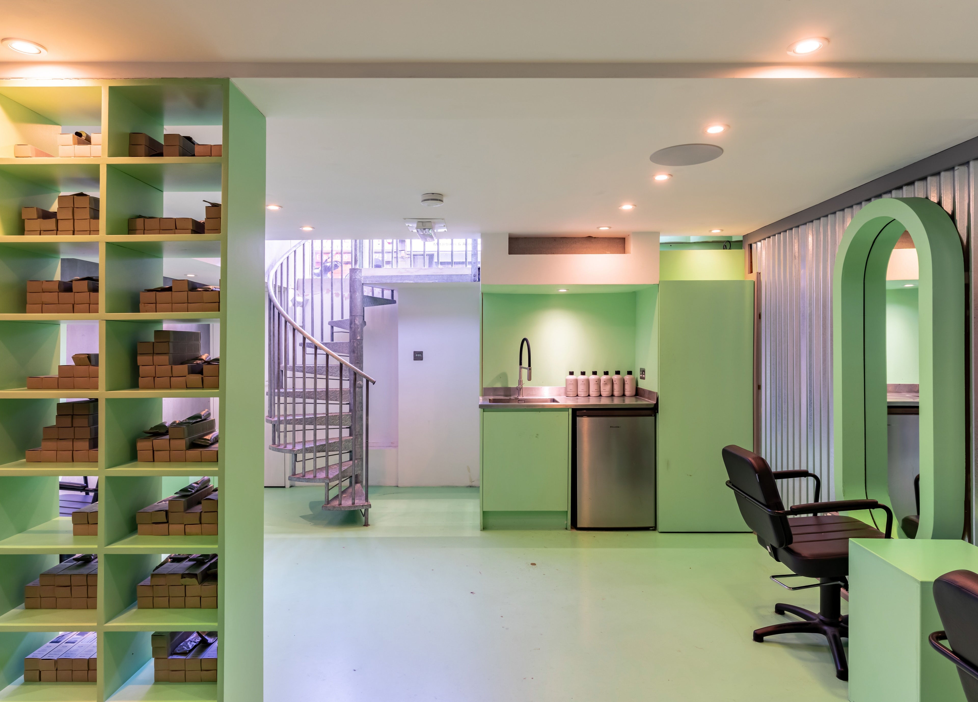 Modern interior at Crab Salad Highbury, London, GB. Features sleek shelving and comfortable seating.