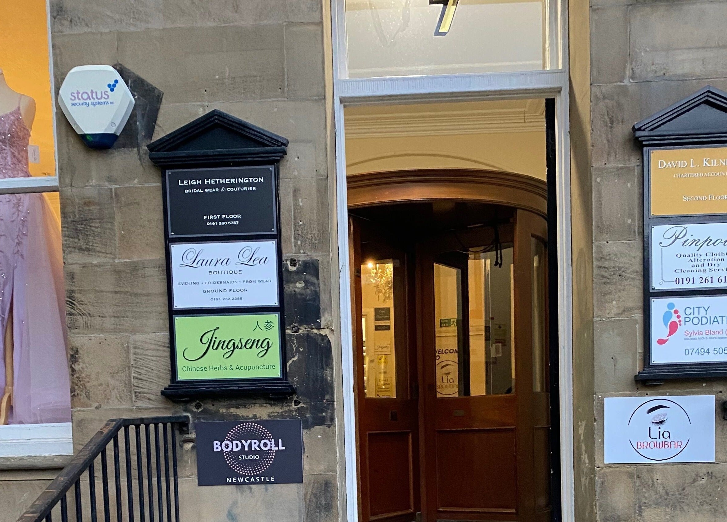 Entrance of Bodyroll Studio Newcastle Ltd at Newcastle upon Tyne, England, GB with shop signs and a mannequin.