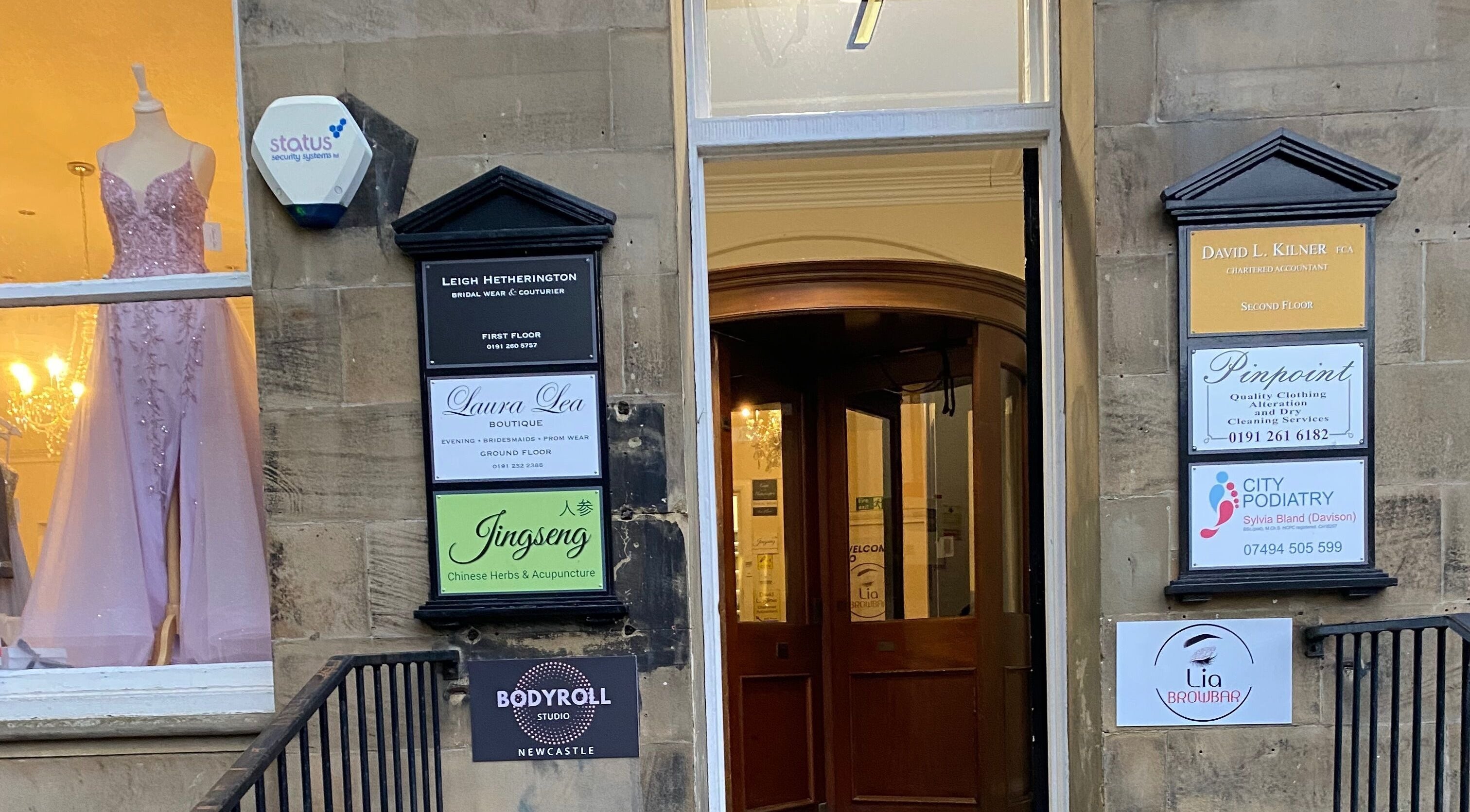 Entrance of Bodyroll Studio Newcastle Ltd at Newcastle upon Tyne, England, GB with shop signs and a mannequin.
